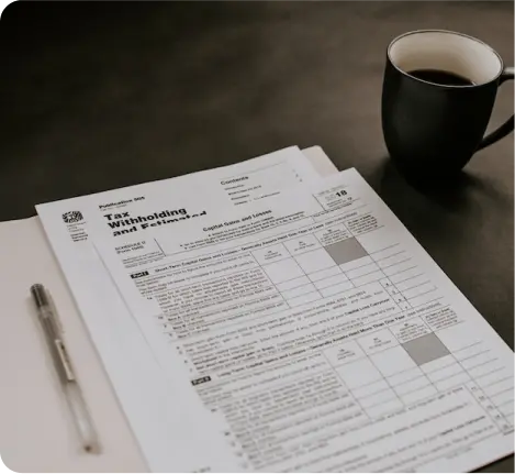 Tax withholding document on table next to coffee cup