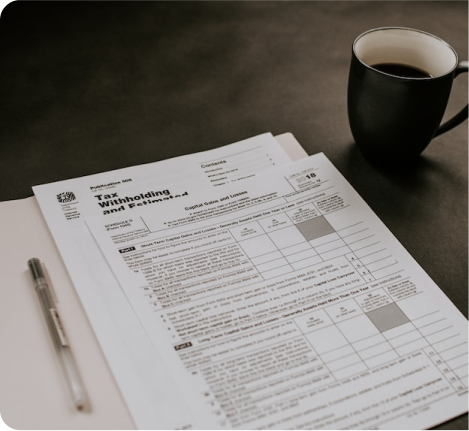 Tax withholding document on table next to coffee cup