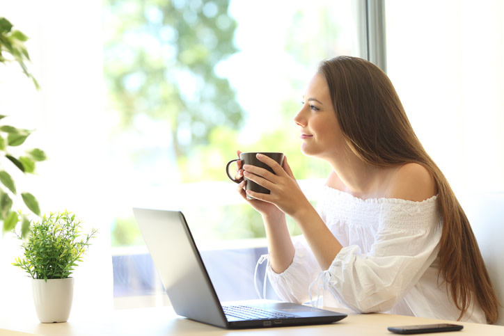 woman checking daily deals on laptop