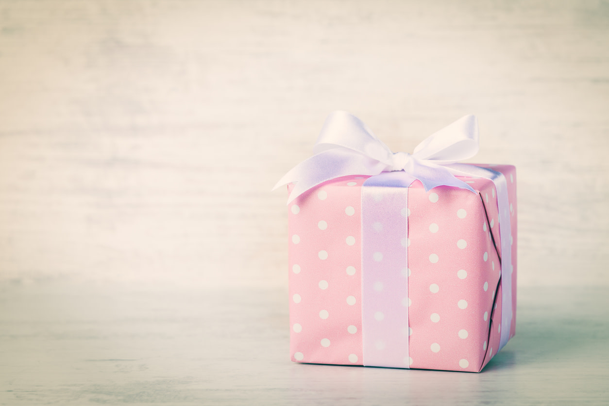 Gift box wrapped in pink dotted paper. Vintage effect filter.