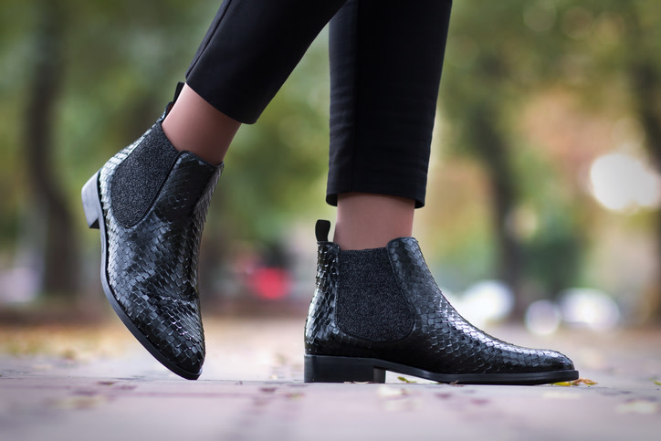A girl steps in python leather shoes