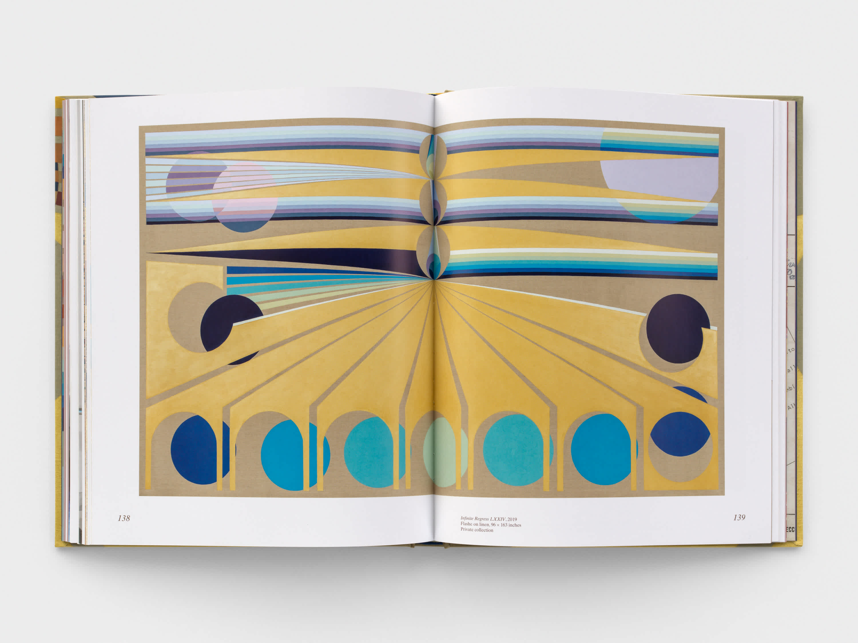 Open book with blue and yellow geometric artwork on both pages.