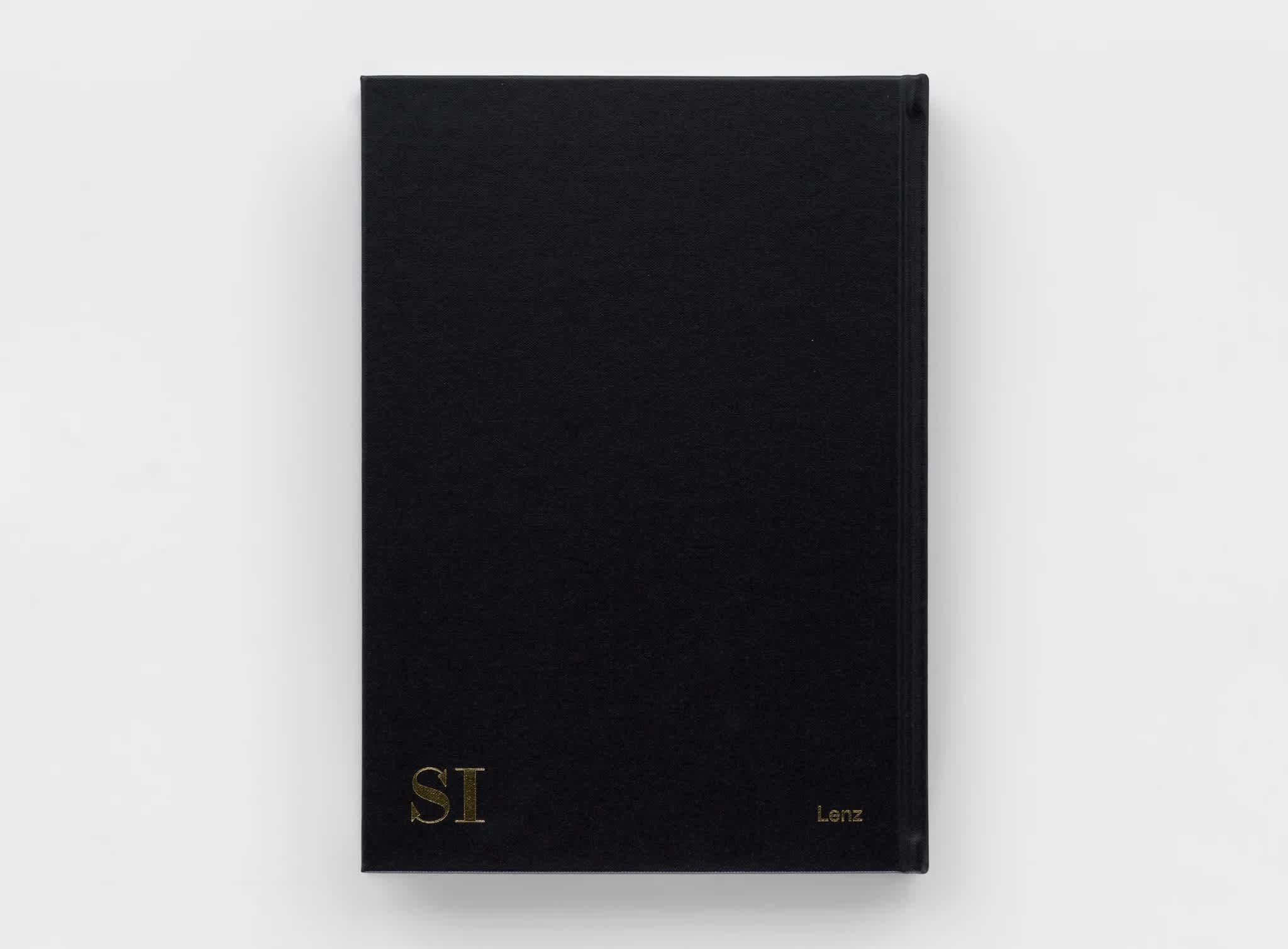 Back cover of a black book. "SI" is embossed in gold on the bottom left corner.