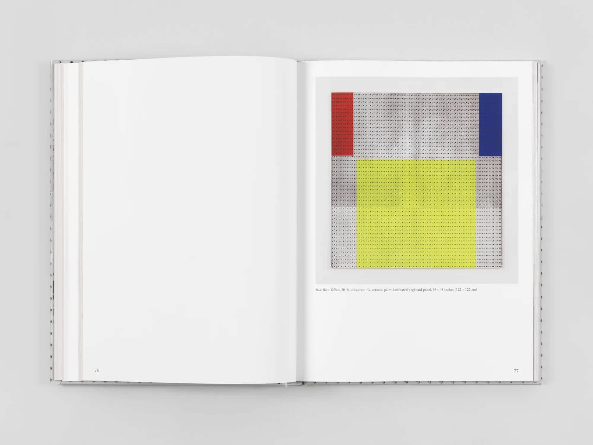Open book with blank white page on the left and an artwork of primary colors on the right.