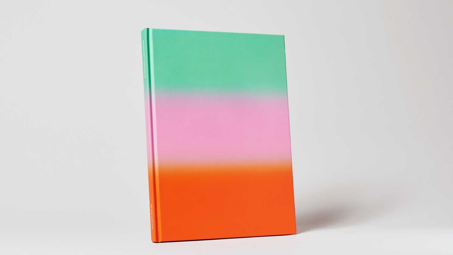 Upright book painted in descending swatches of green, pink and orange.