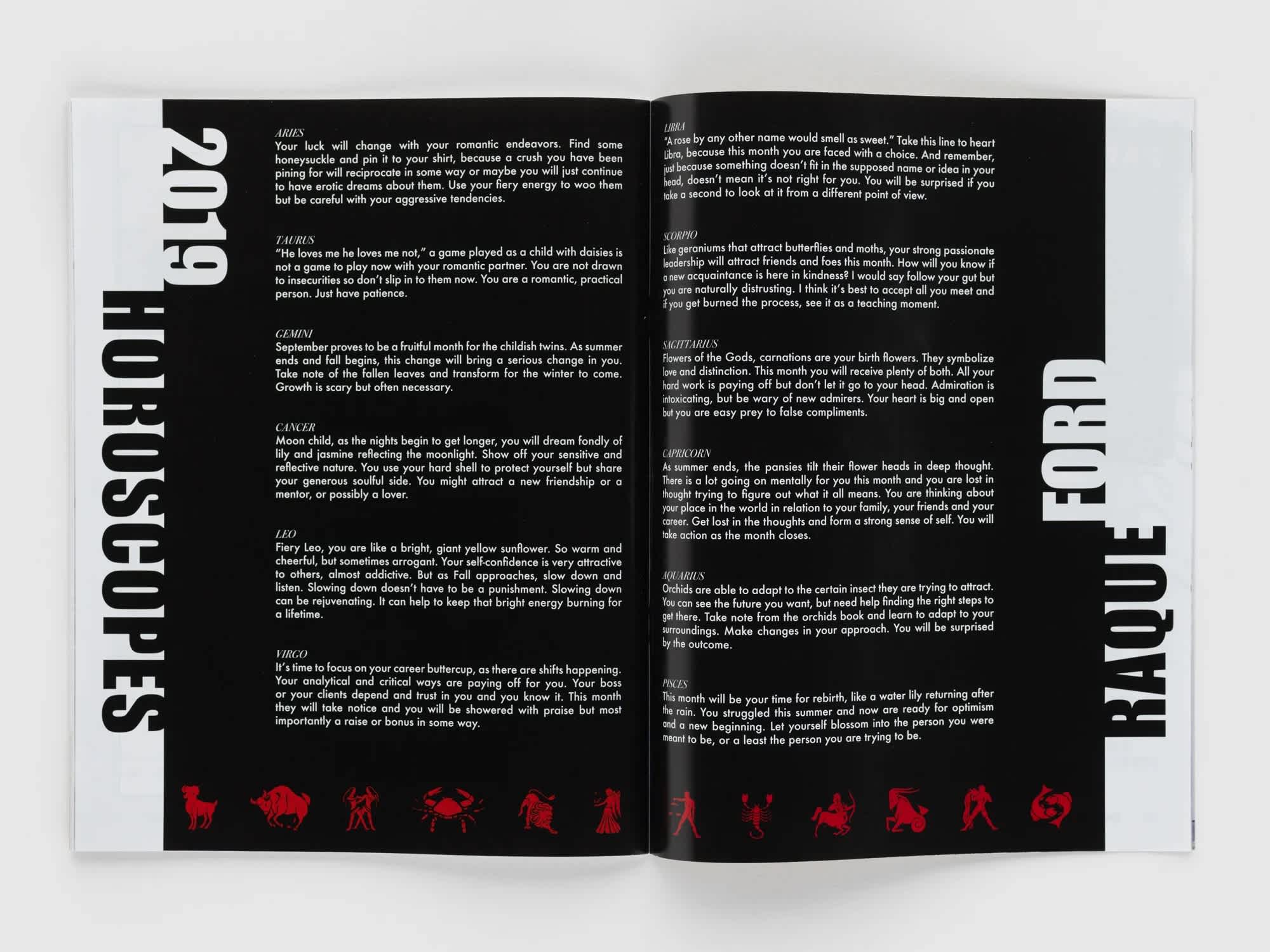 Open book with black pages and white text.