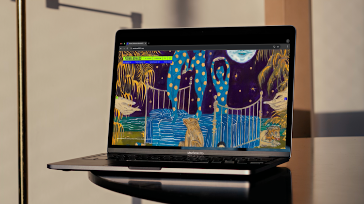 video of a laptop on a table scrolling through a website.