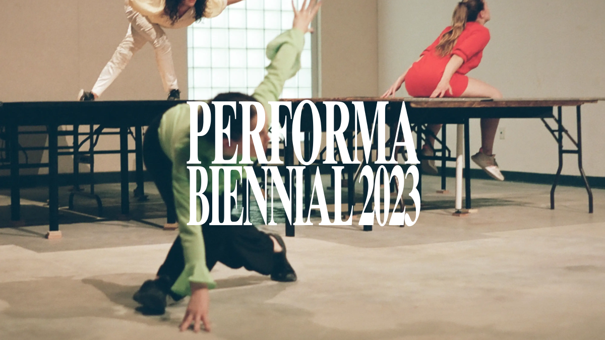 A group of dancers in various colorful shirts are positioned on and around tables. The white Performa Biennial 2023 logo is centered on the image.