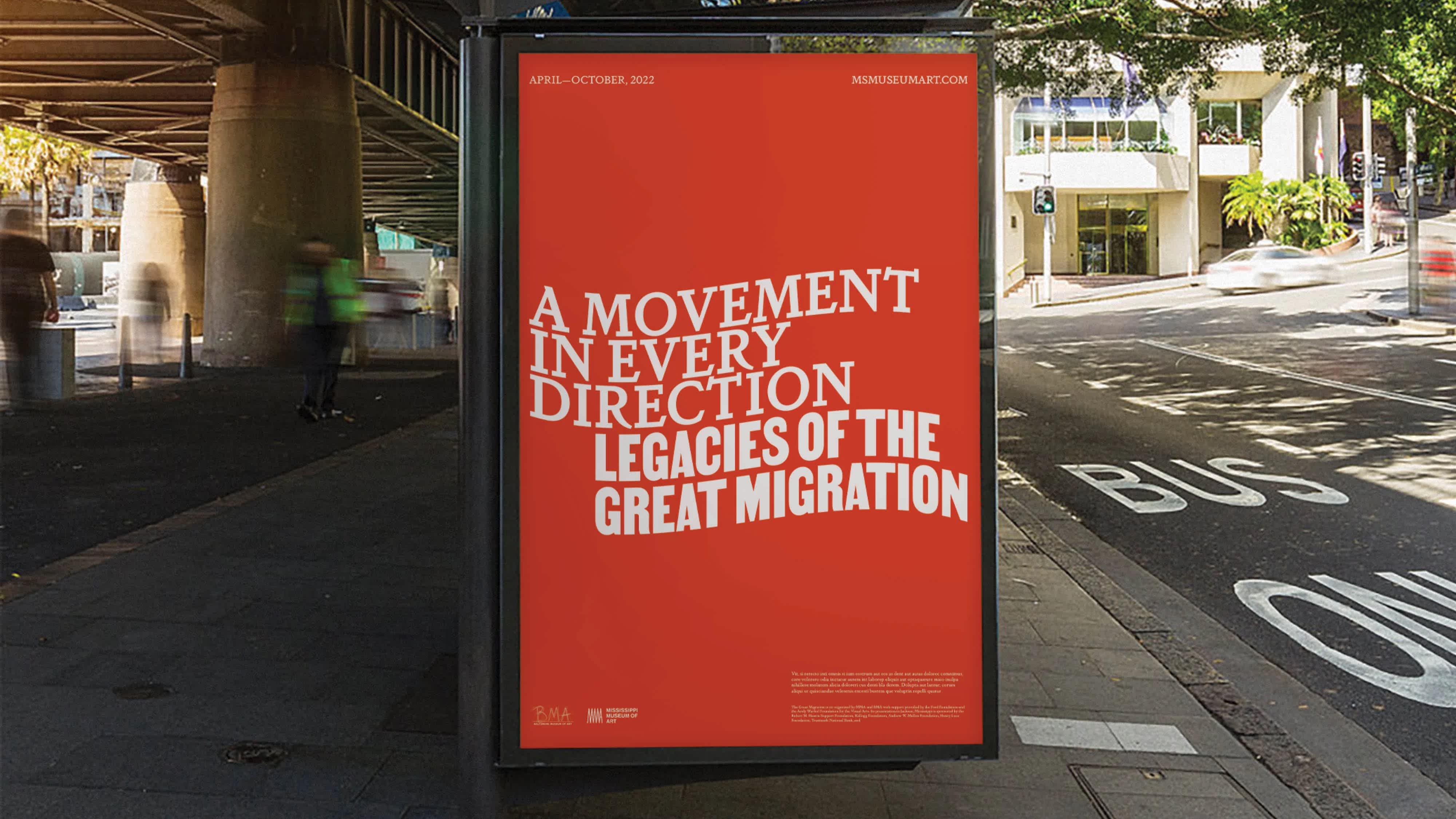 An ad on the side of a bus stop underneath an underpass. The ad is bright with white text advertising an exhibition.