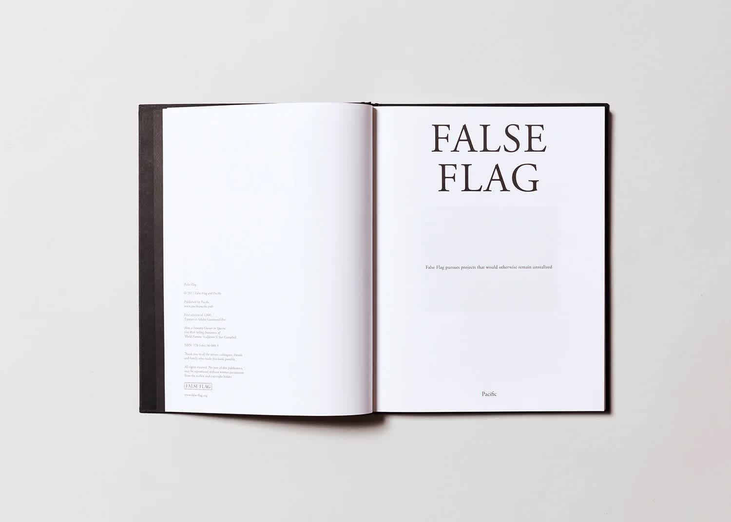 A book open to the title page. The paper is white and the colophon and title text is black.