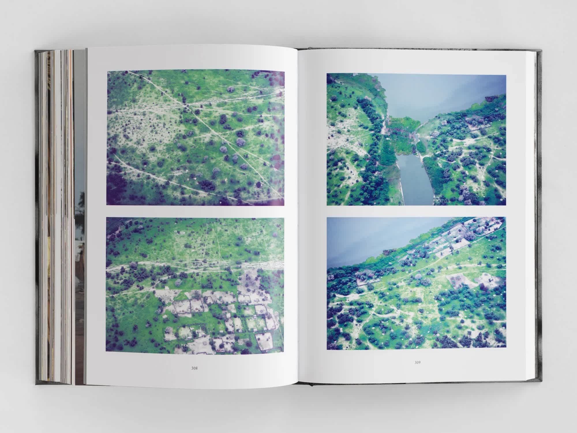 Four aerial photographs of a village and river delta split onto two pages of an open book.