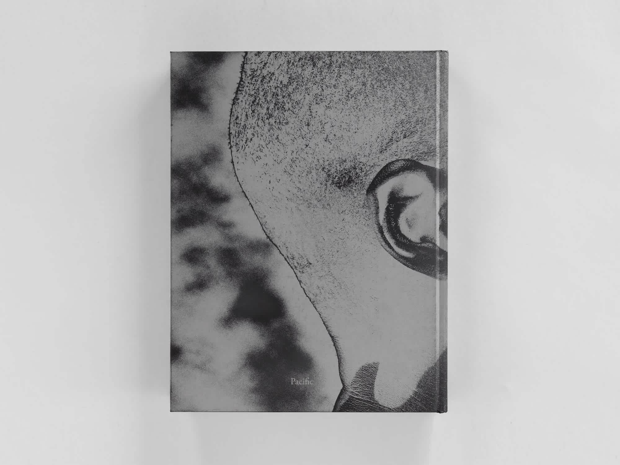 Back cover of a book. The cover art is a black and white photo of the back of a man's head in side-profile.