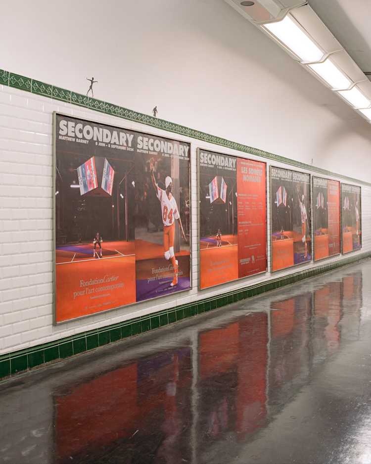 Image of multiple poster in a subway station with men in football uniforms.