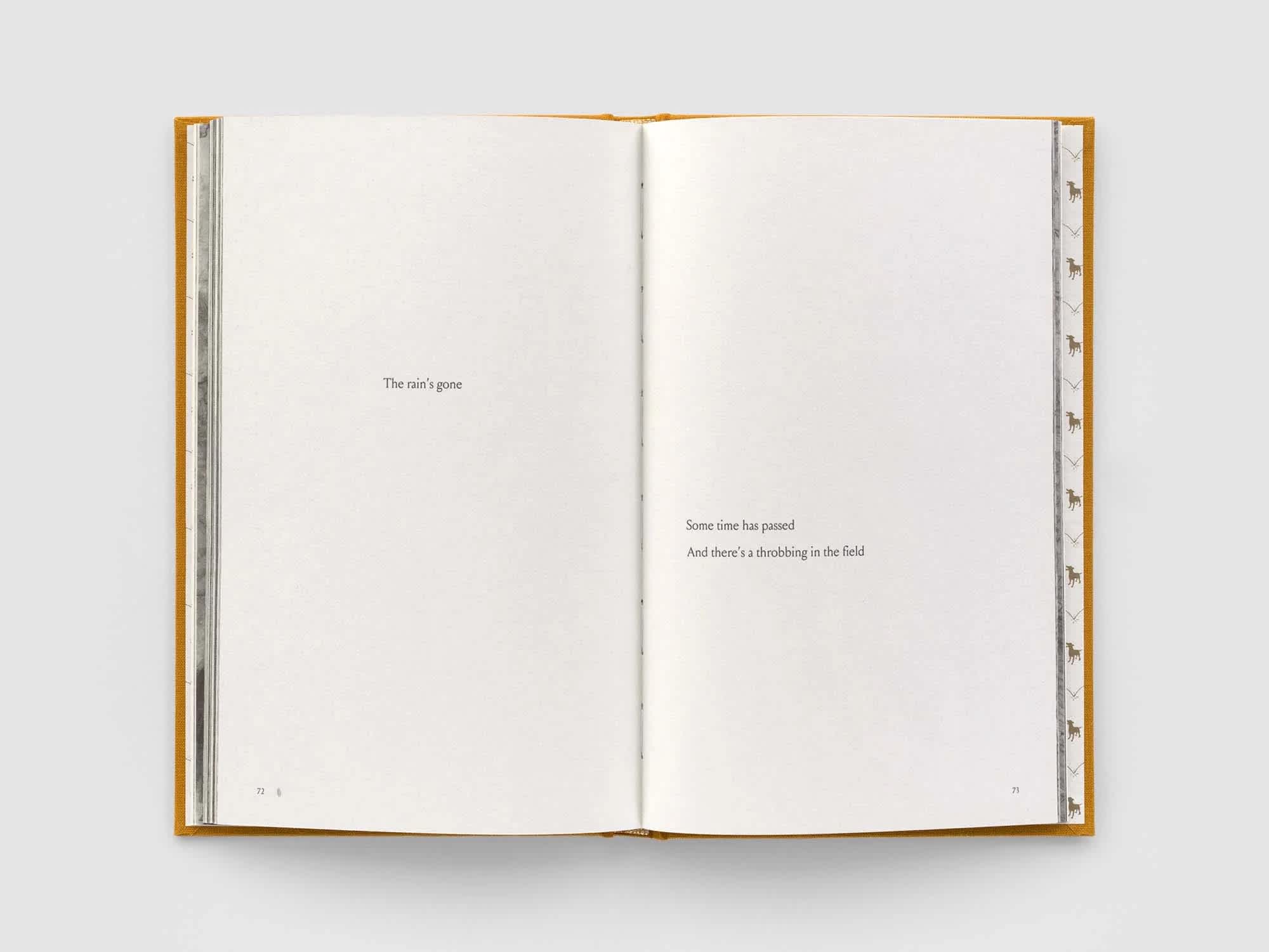 Open book with one line of text on the left page. Two lines of text are on the right page.