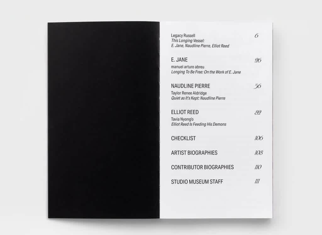 Open book with black left page and table of contents on the right.