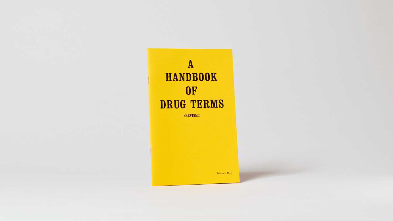 Bright yellow book with black text, standing upright.