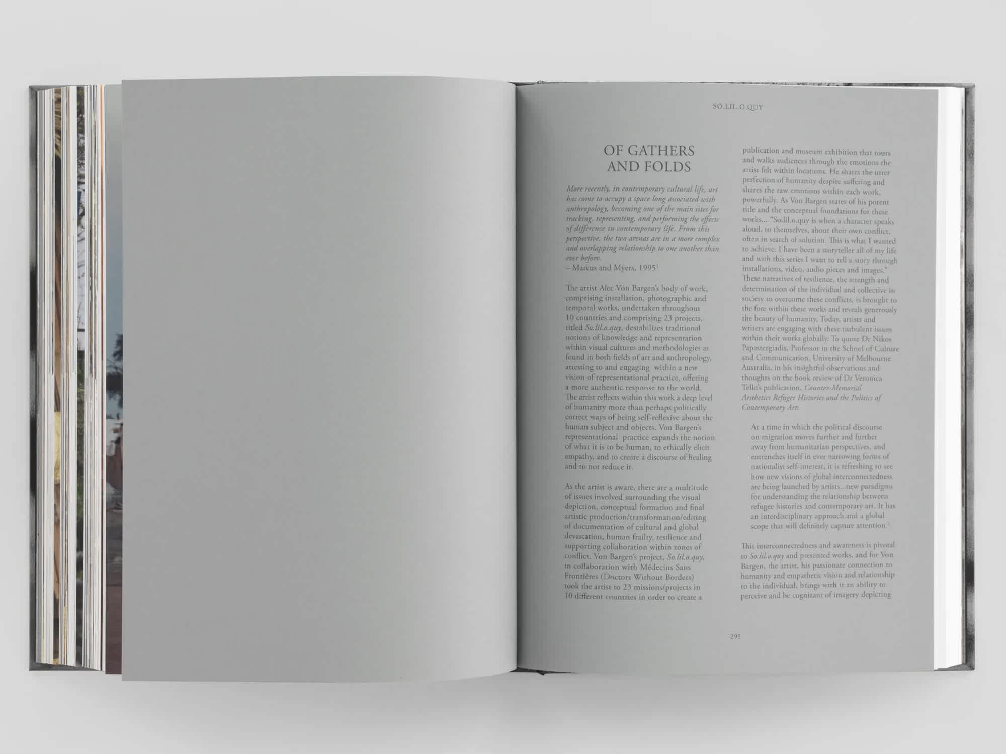 Open book with two gray pages. The left page is blank. The right page has two columns of black text.