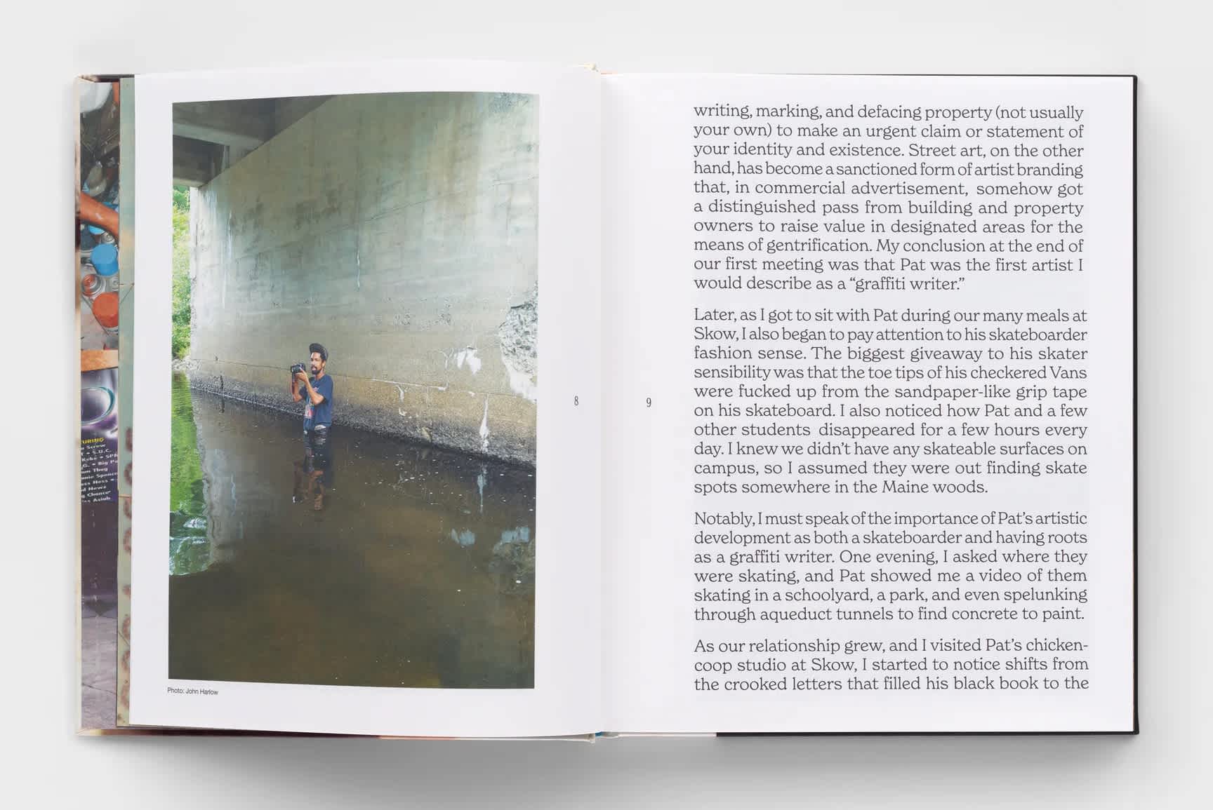 Open book with a photograph of a man standing in water under a bridge on the left page. The right page is filled with text.