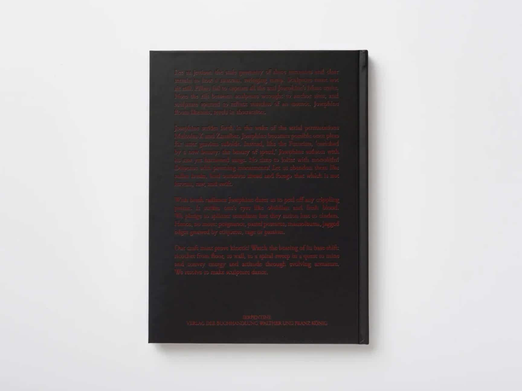 Back cover of a book with red embossed script on black board.