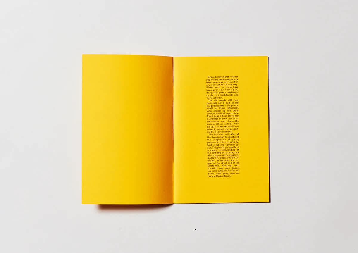 Bright yellow book that's open. The right page has a center column of black text.