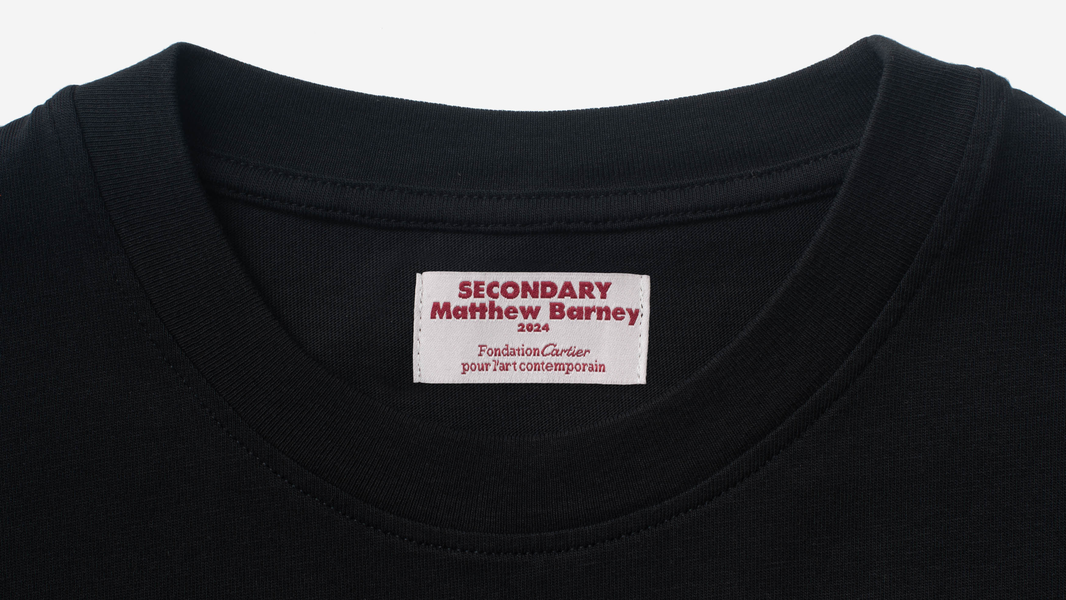 Image of a T-shirt tag which says "Secondary, Matthew Barney, 2024, Fondation Cartier pour l'art contemporain.