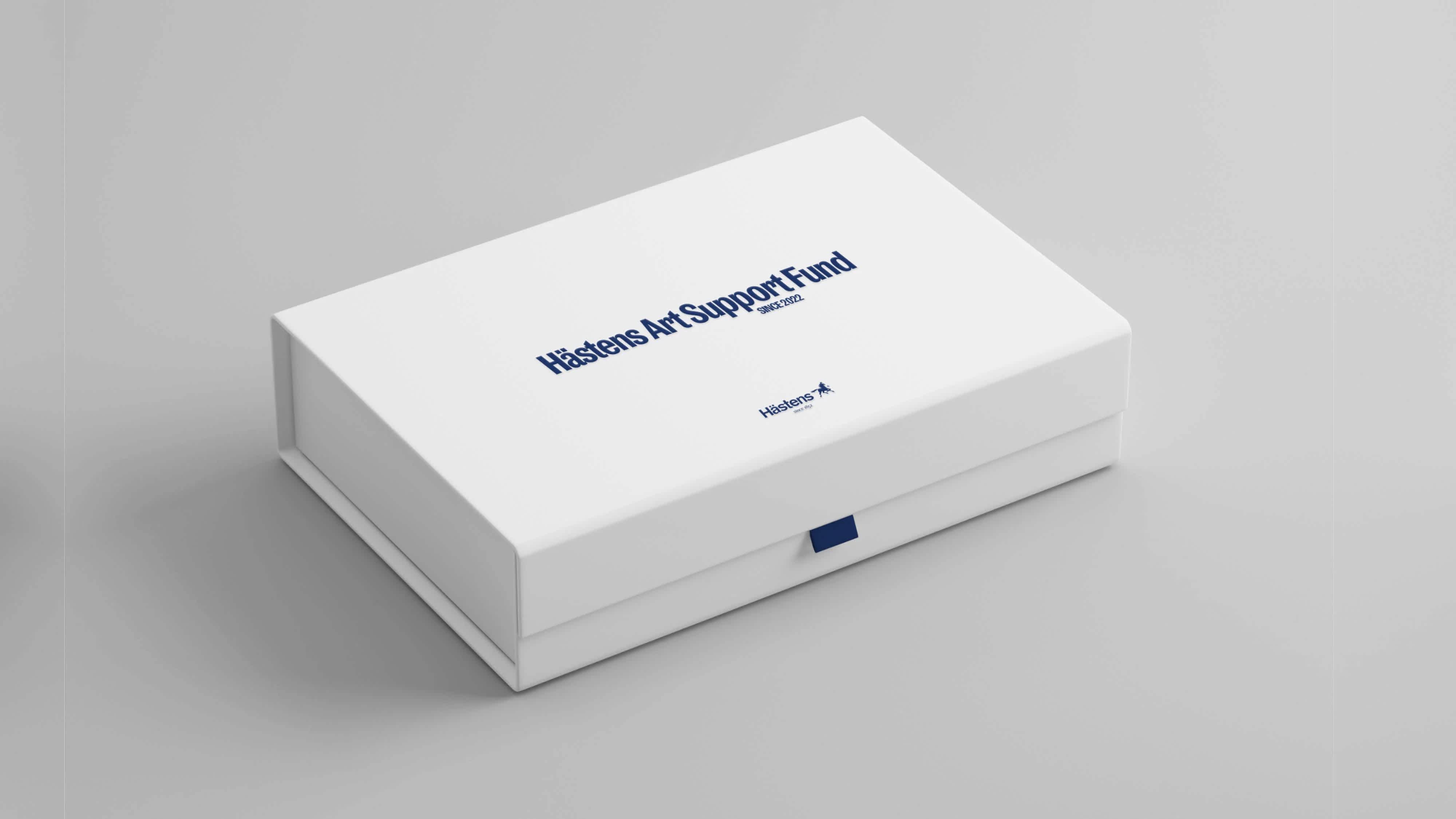 A white box with a navy blue pull tab and navy blue text on the lid.