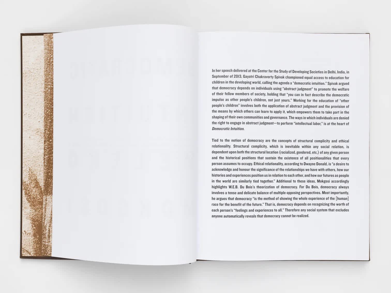 Open book with blank left page and black text on the right.