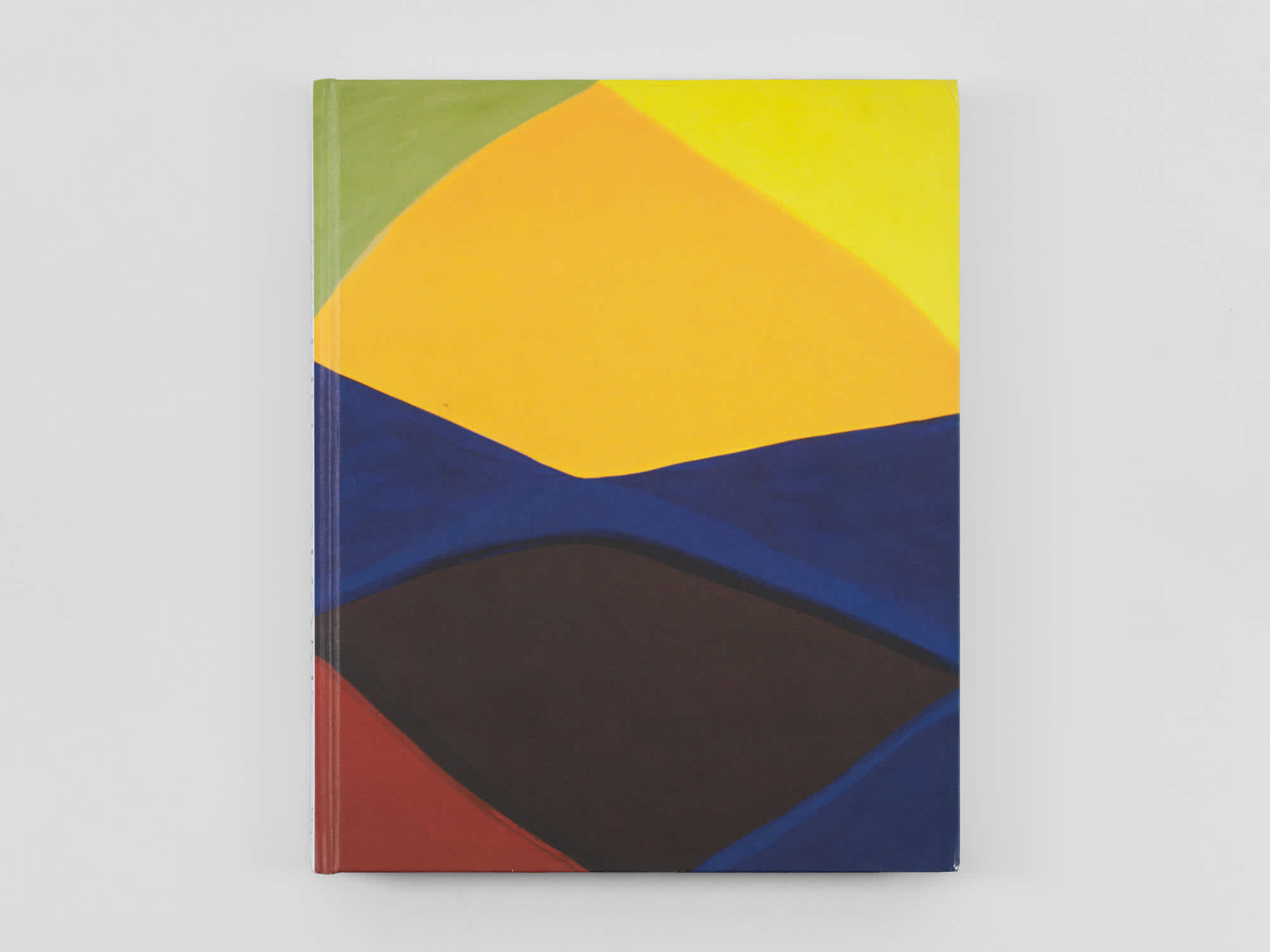 Front cover of a book. It's painted in green, gold, yellow, blue, brown and red triangles.