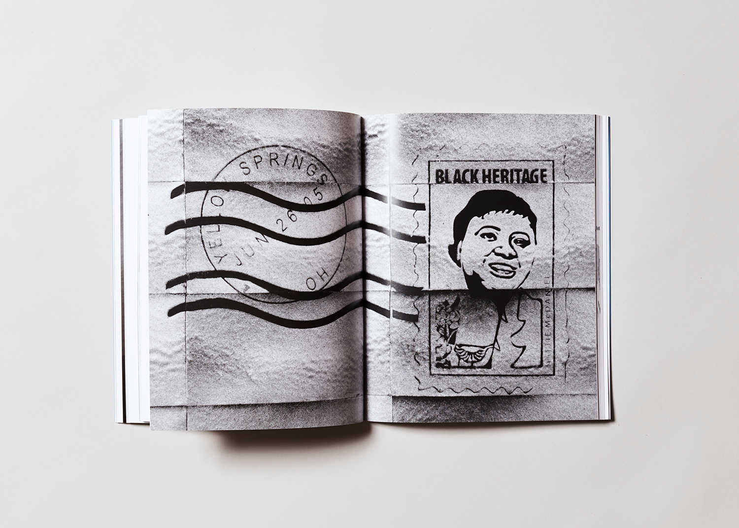 Book interior. Full bleed, centerfold of a great and black artwork by the artist Mary Kelly.