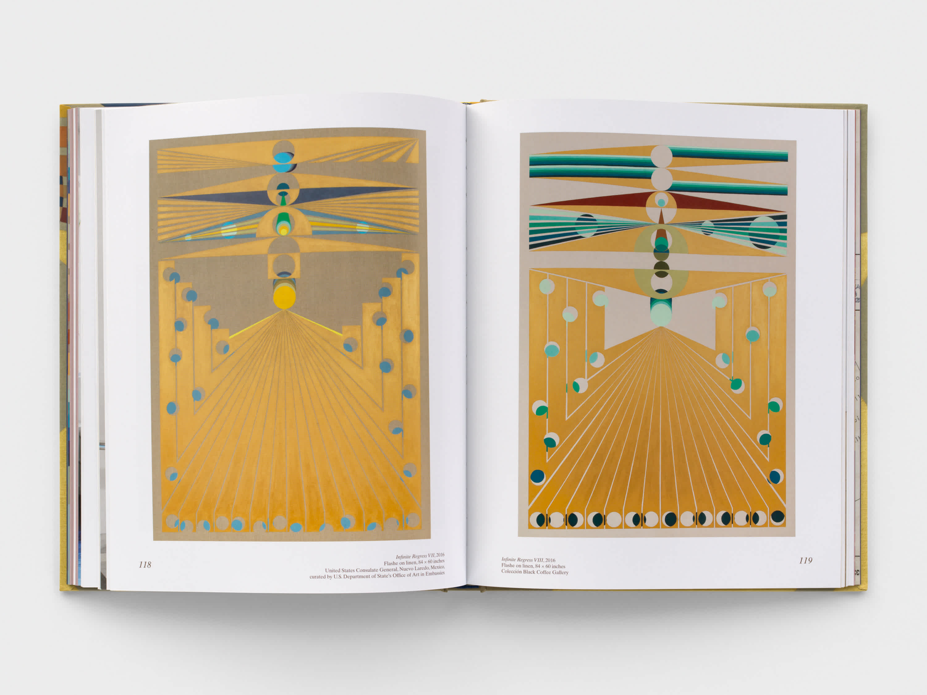 Open book with two, predominantly yellow geometric artworks on either page.