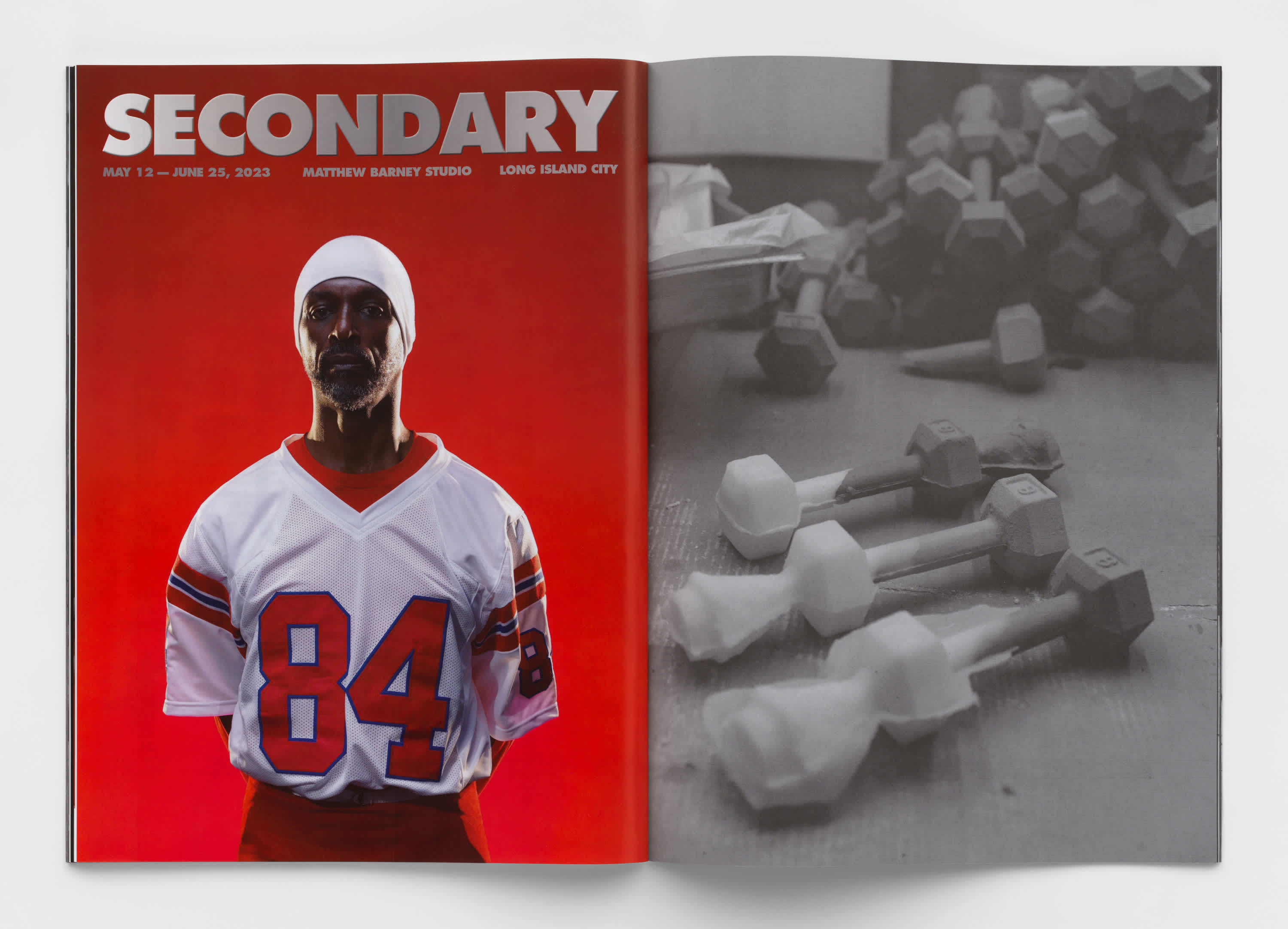 Two page book spread. The left page features a football player standing in front of a red background, the title 'Secondary' is above his head. The right page is a black and white photograph of cast dumbbells on the floor. 