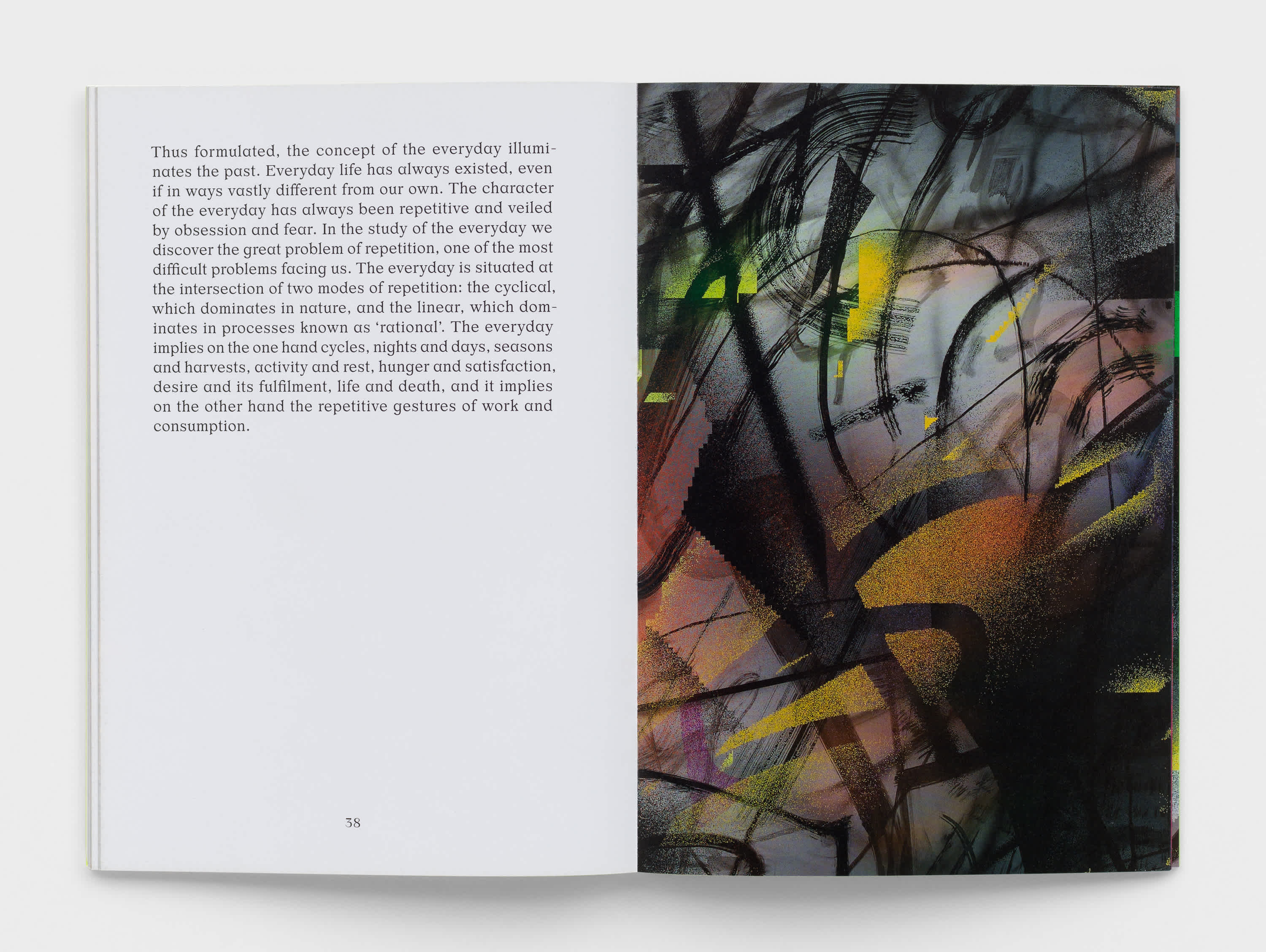 Open book with text on the left page and a dark abstract artwork on the right page.