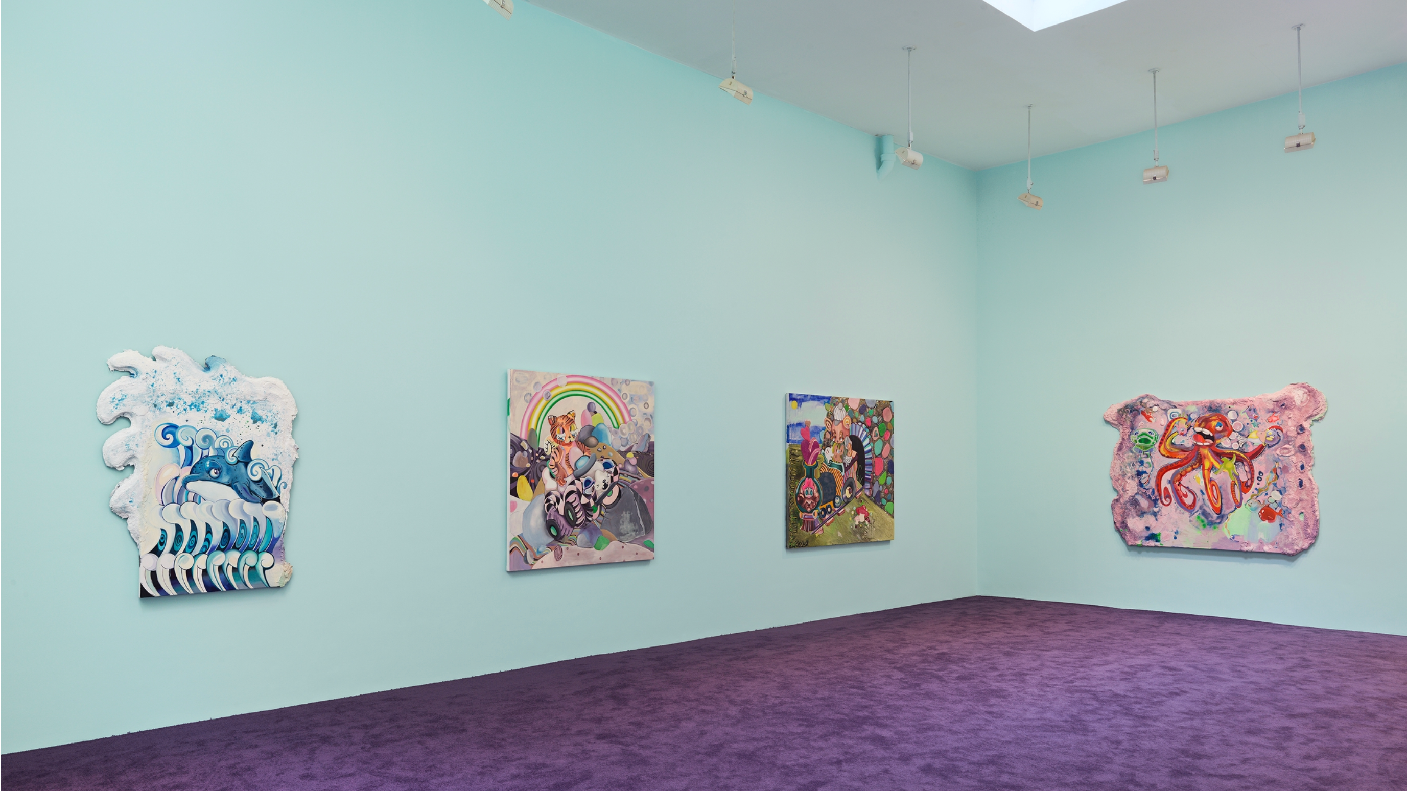 A corner of a room in which four colorful paintings hang on a light blue wall. The carpet on the floor is deep purple and the corner of a skylight can be seen peeking out at the top of the image.
