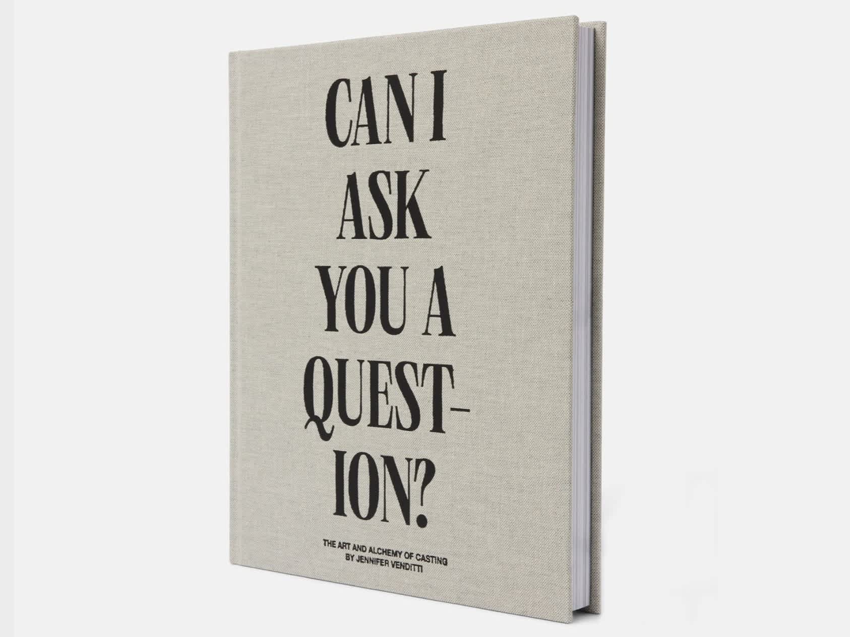 Book with gray woven cover and the title "Can I Ask You A Question?" embossed in black. The book is turned 1/4 so as to see the pages.