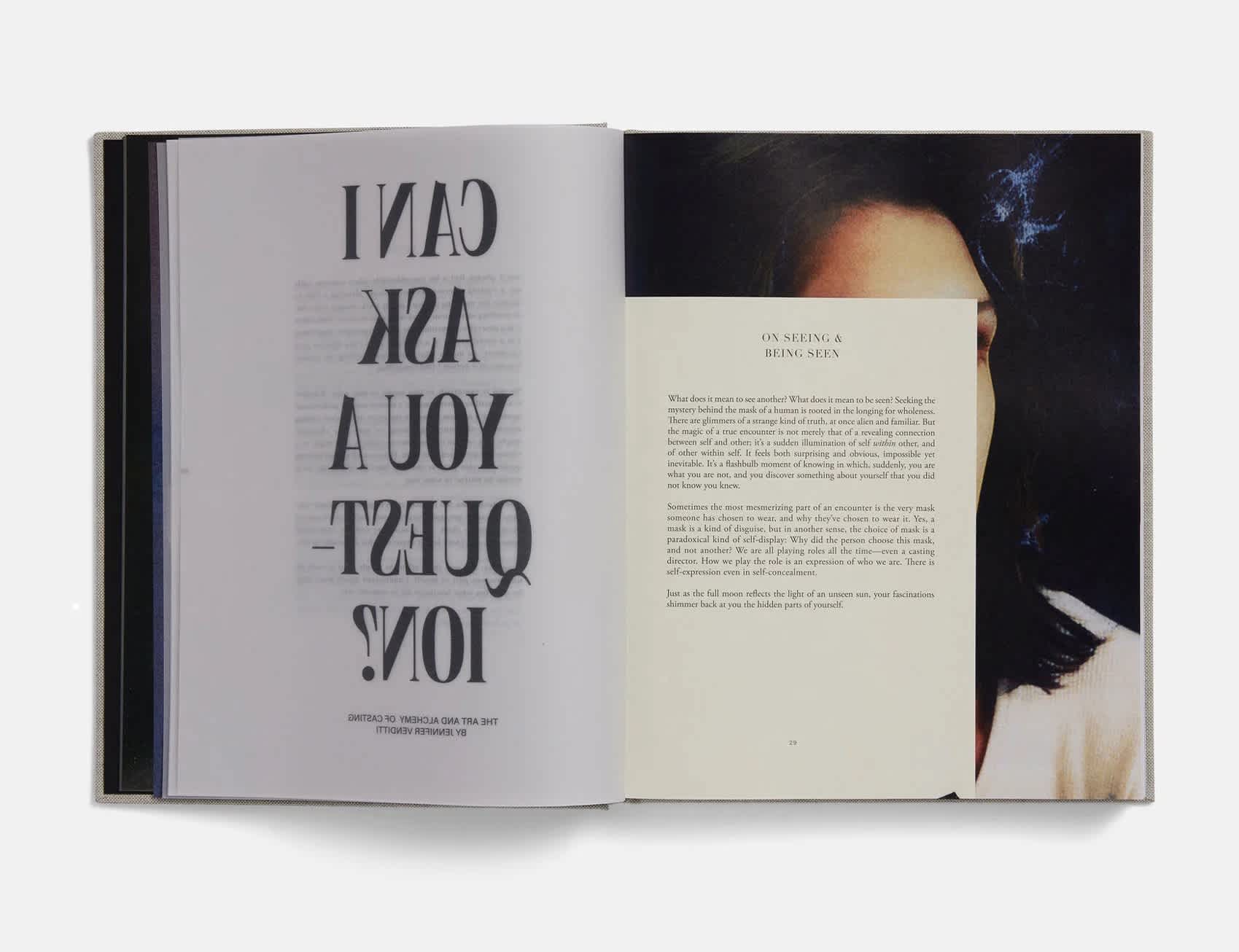 Open book. The left page has a mirrored block of black text on a transparent page. The right page features a typed letter on top of an image of a person with shoulder-length hair.