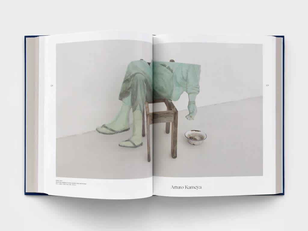 Open book with a centerfold image of a sculpture.