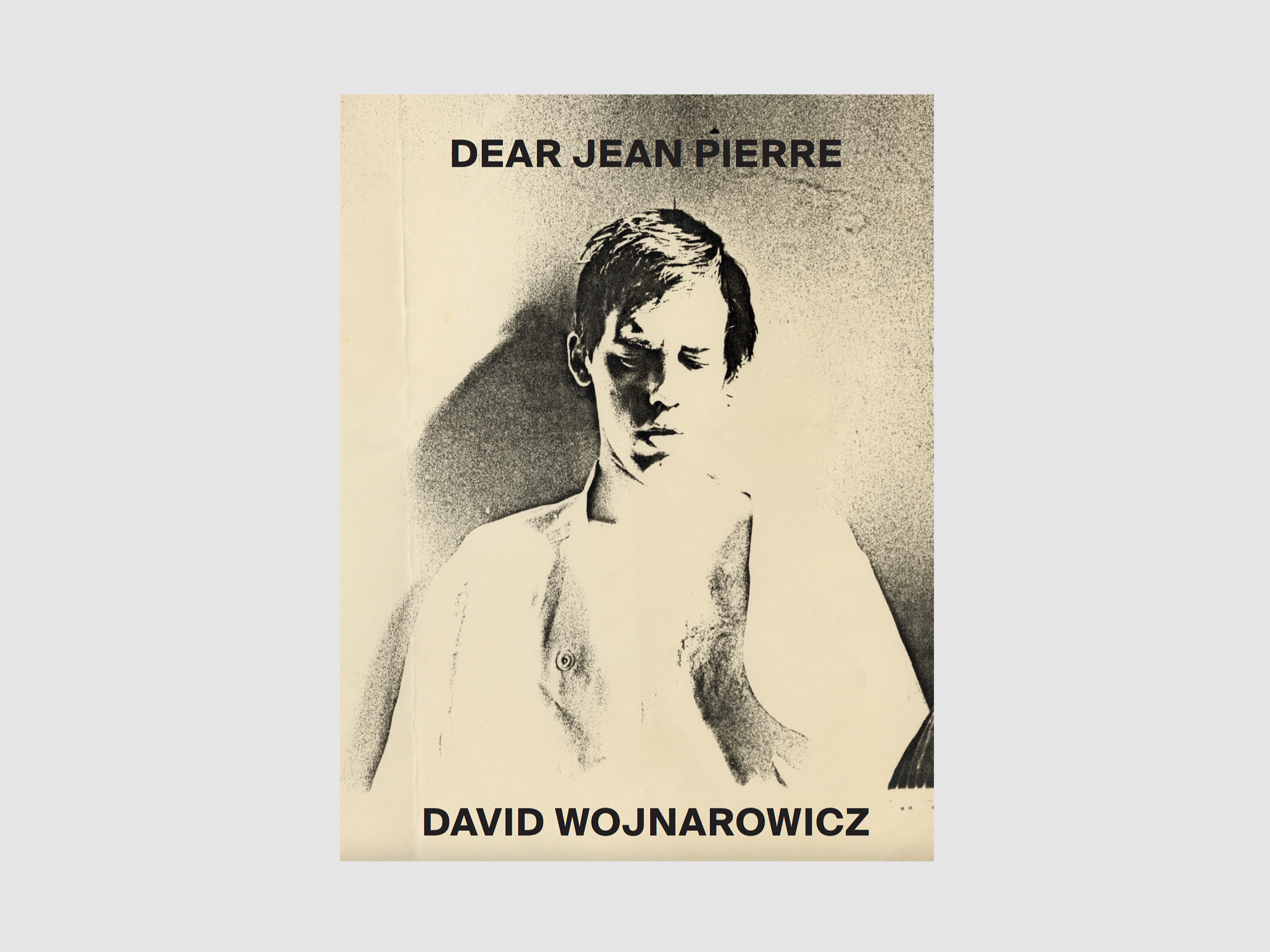An image of the artist, David Wojnarowicz, is rendered in tan and black on a book cover. The title of the book and the artist's name sit at the top and bottom of the cover. 
