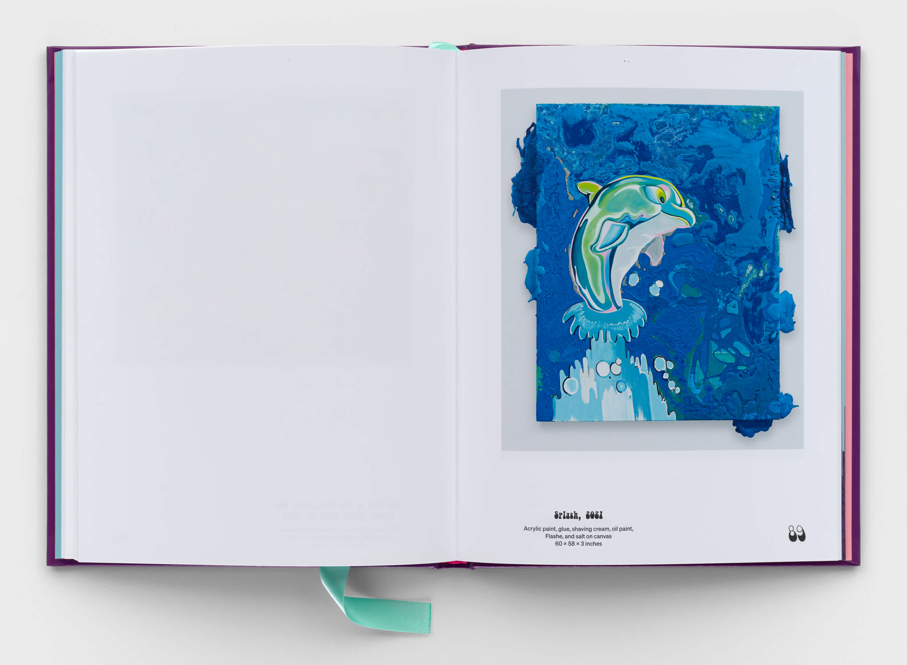 An open book that displays a painting of a blue, cartoon dolphin jumping out of the water on the right page. The left page is blank. 