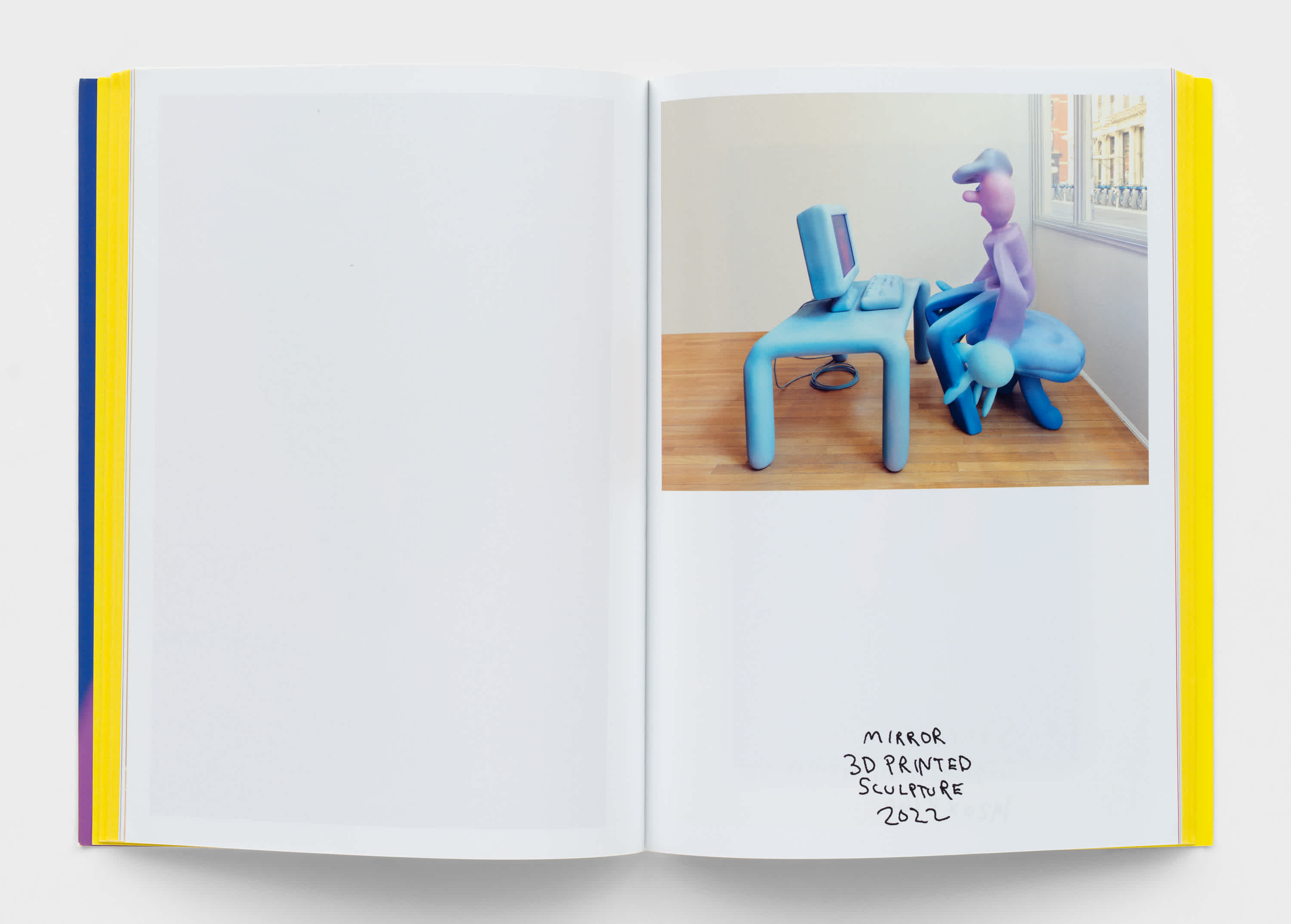 Open book with one image of a 3d printed sculpture on the top half of the right page. The sculpture is of a cartoon man with an enlarged hand, sitting at a desk. The sculpture information is scrawled in black penmanship at the bottom of the page.