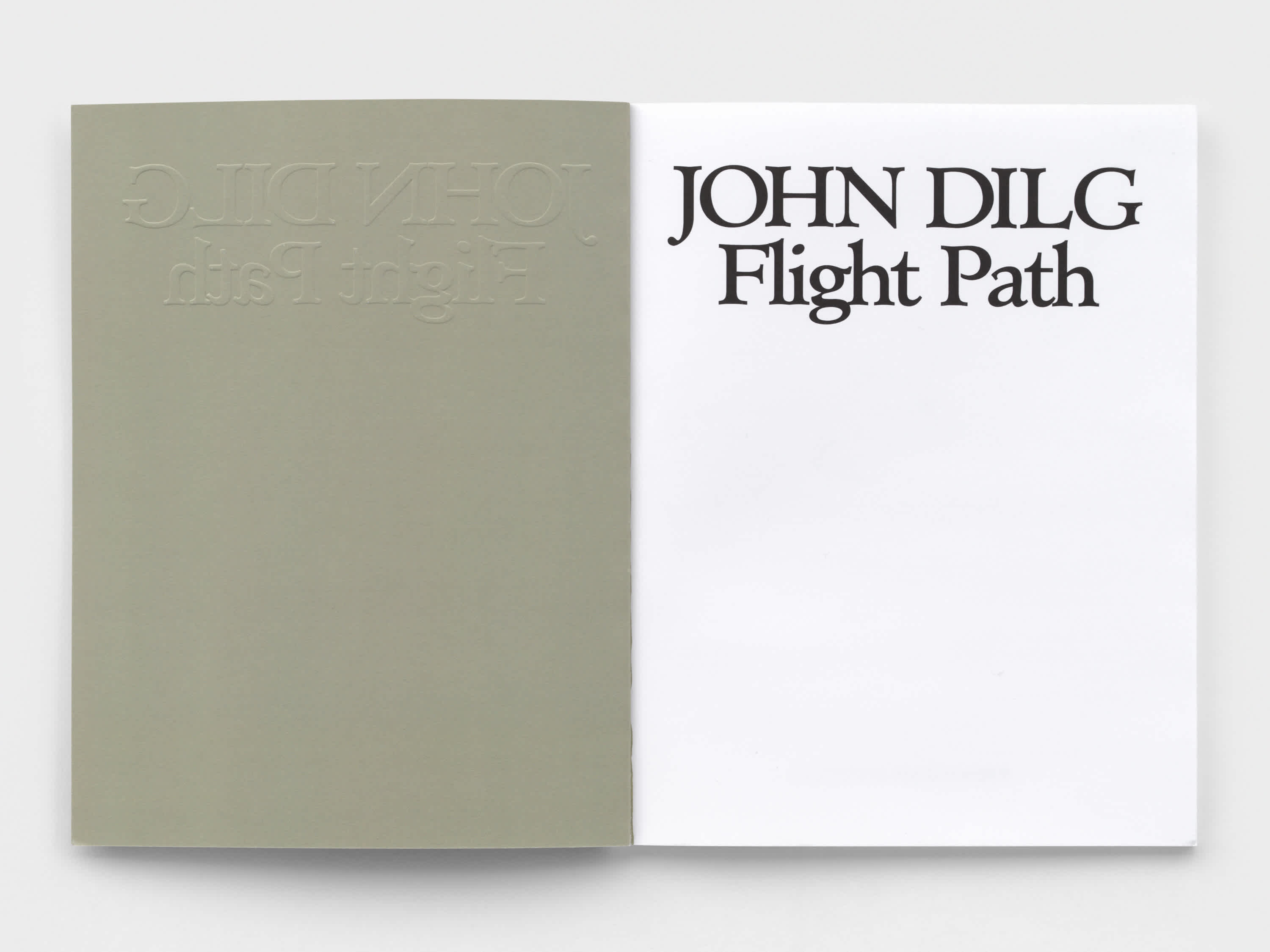 Open book with white page and title printed in black letters at the top. The cover interior is light gray.