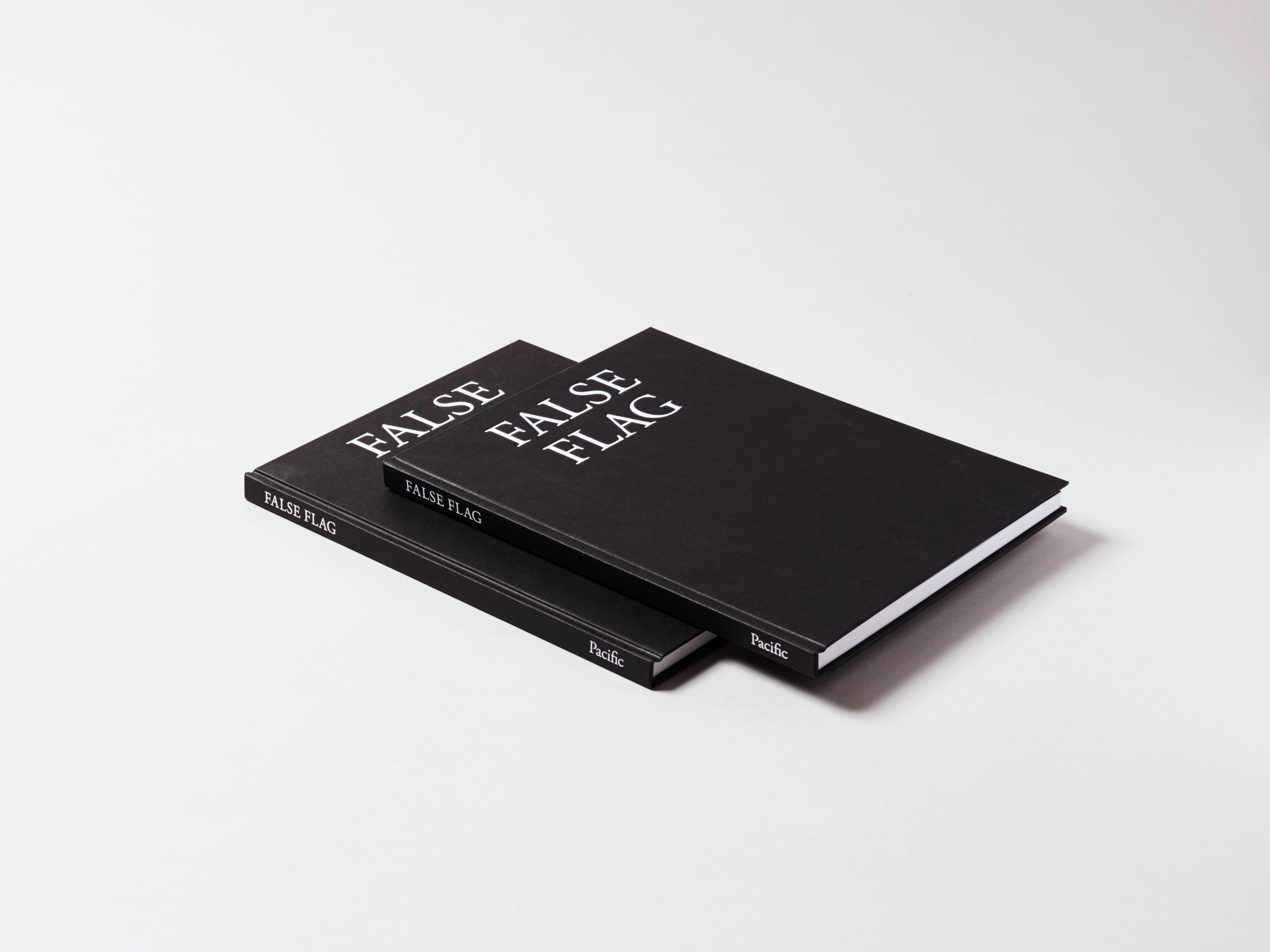 Two black books with white title text stacked on top of each other. They are oriented diagonally in the frame so that the spines are visible.