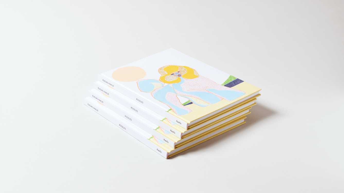Stack of four identical books. A colorful yellow, pink and blue painterly poodle is on the cover of the top book.