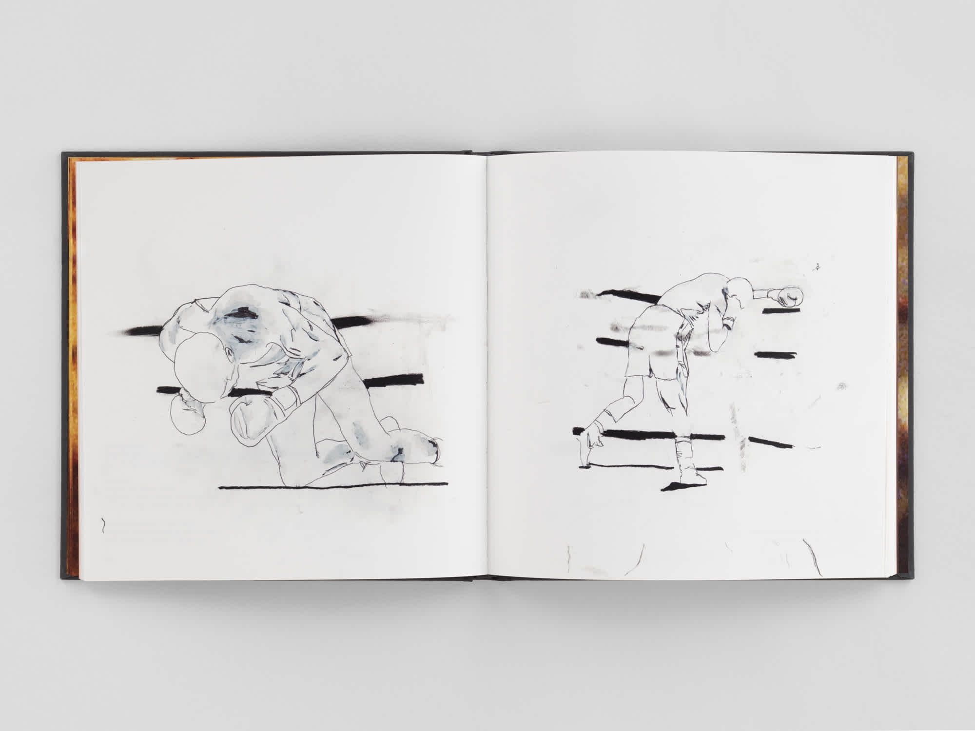 Open book with a different sketch of a boxer on each page.