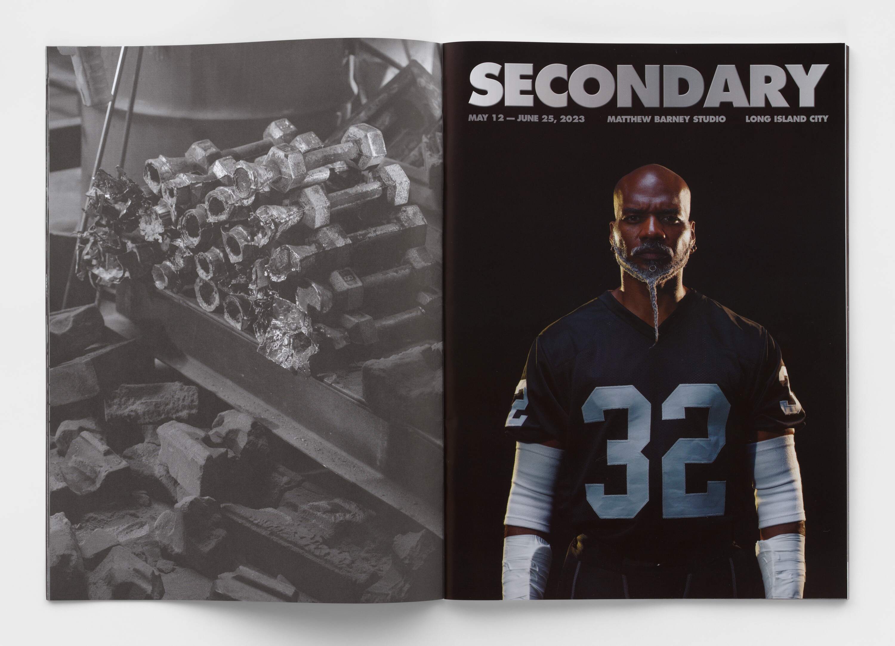 Image of an open book on a grey background. 