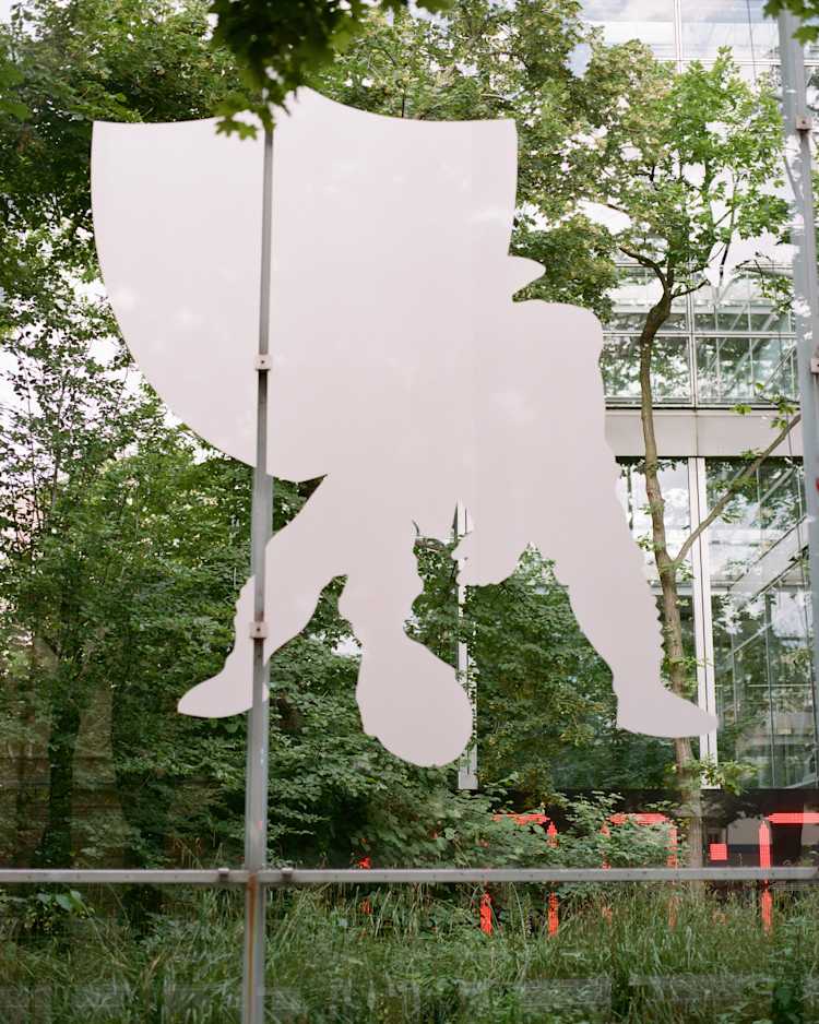 Image of a glass-wall with a large decal featuring a football player about to snap the ball with a shield medallion behind him.
