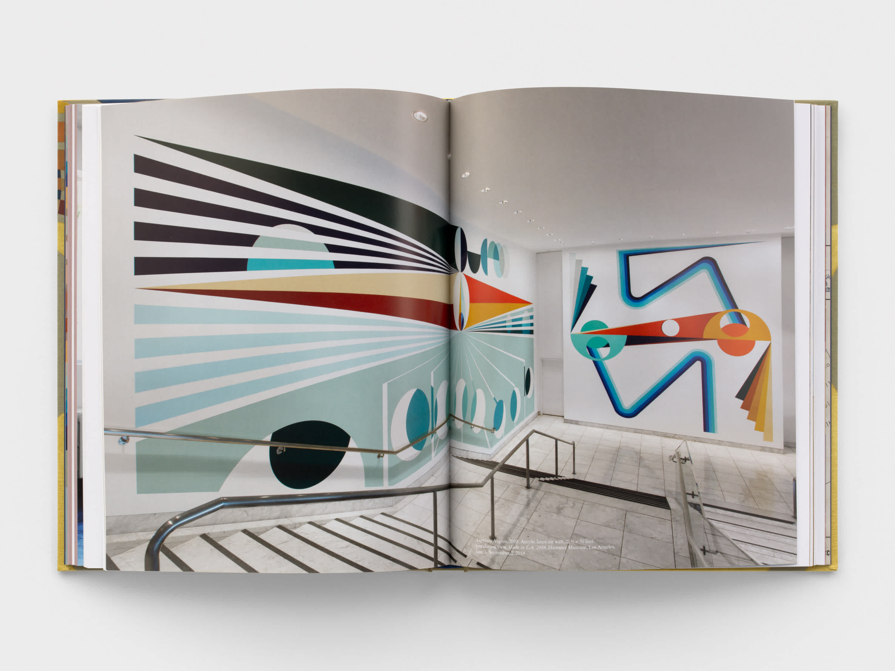 Open book with install shot on both pages.