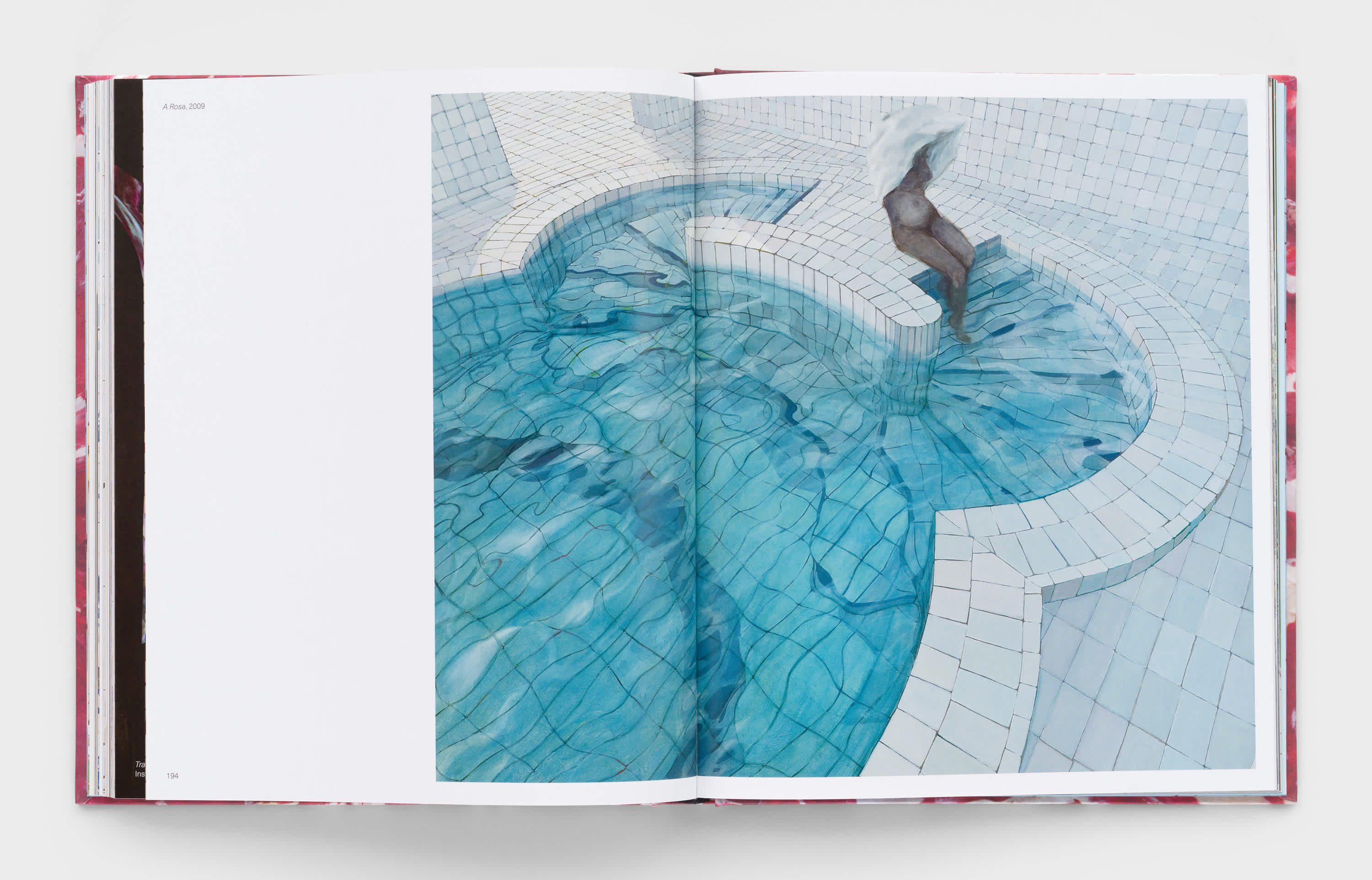Open book showing an artwork depicting a person dipping their feet into a blue tile pool.