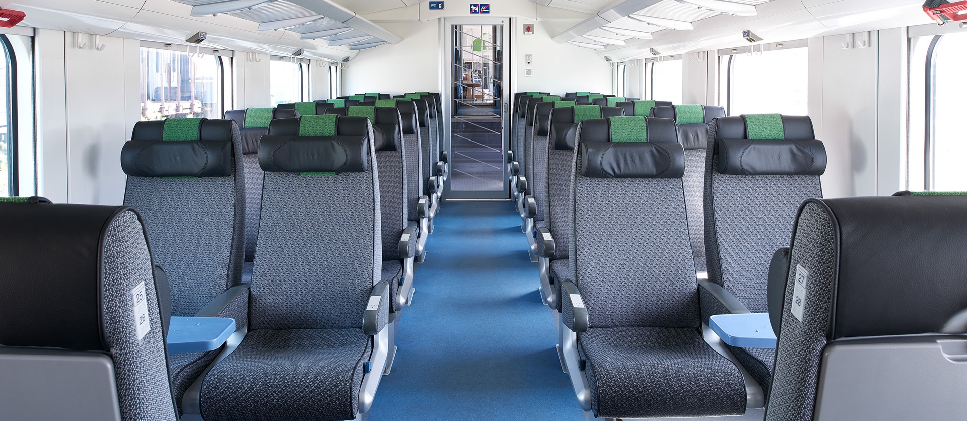 On board InterCity trains, there are two adjacent seats on both sides of the centre aisle. The trains also have seating with tables for four people.