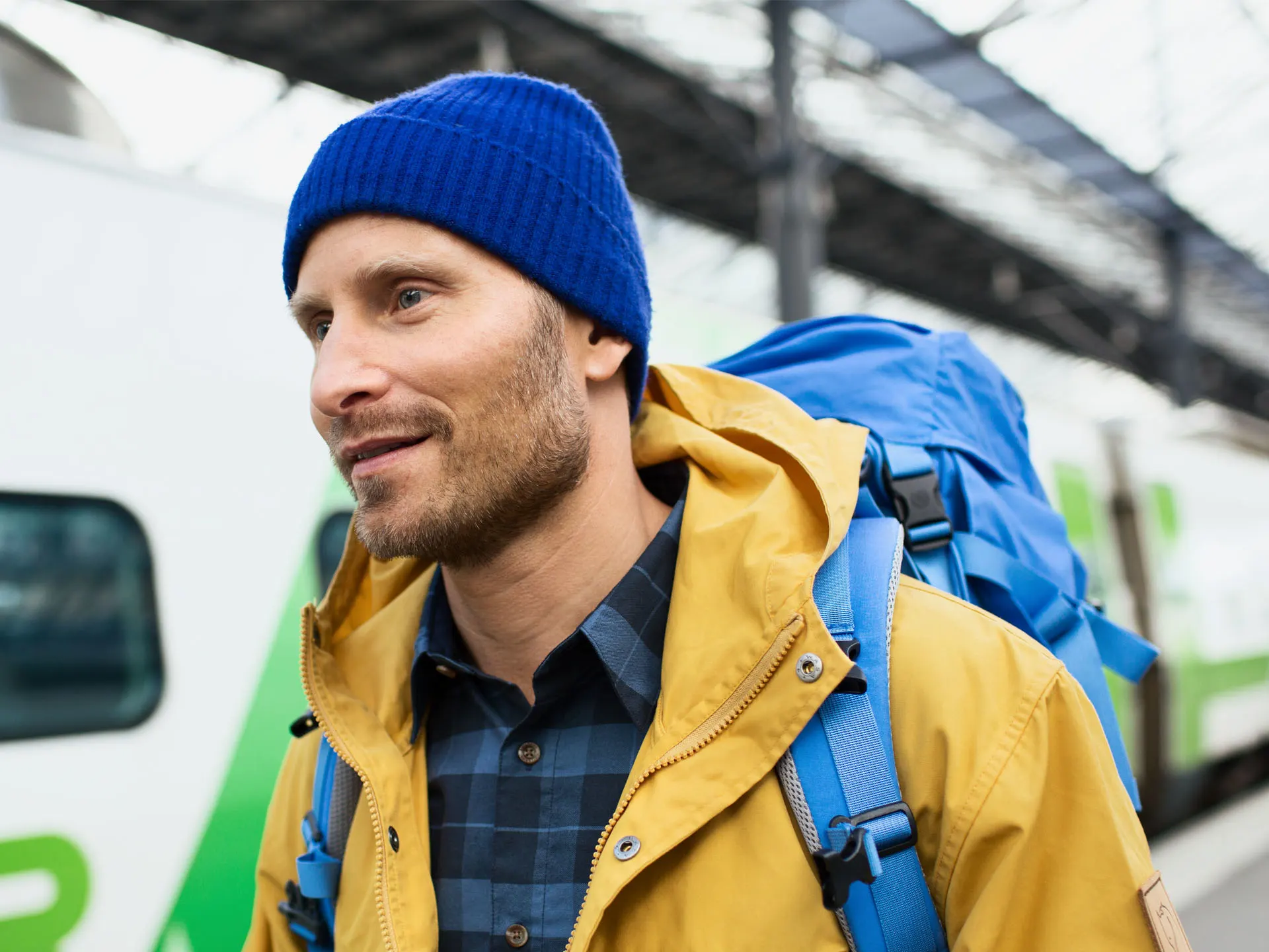 A person undergoing non-military service is boarding a long-distance train.