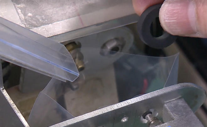 部品の袋を開き、袋詰めをアシスト